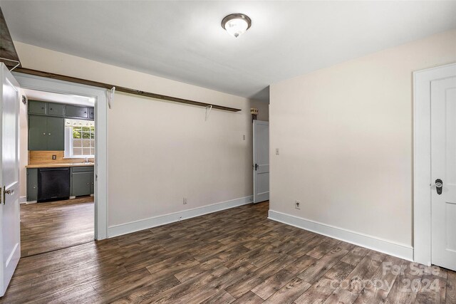 unfurnished room with dark hardwood / wood-style flooring