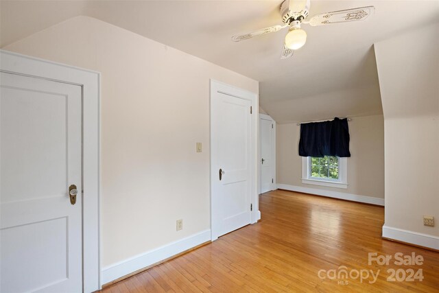 bonus room with lofted ceiling, light wood-type flooring, and ceiling fan