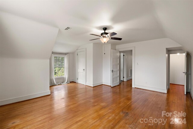 bonus room with lofted ceiling, light hardwood / wood-style floors, and ceiling fan