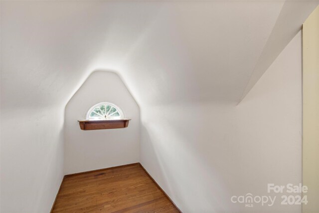 bonus room featuring vaulted ceiling and hardwood / wood-style floors