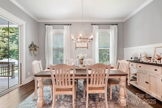 dining space featuring dark hardwood / wood-style floors, an inviting chandelier, and crown molding