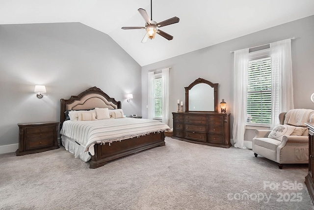 carpeted bedroom with ceiling fan, lofted ceiling, and multiple windows