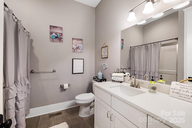 bathroom featuring vanity and toilet