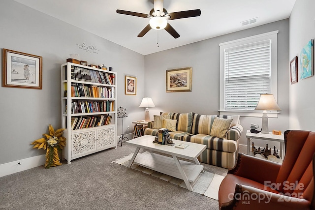 living room featuring carpet flooring and ceiling fan