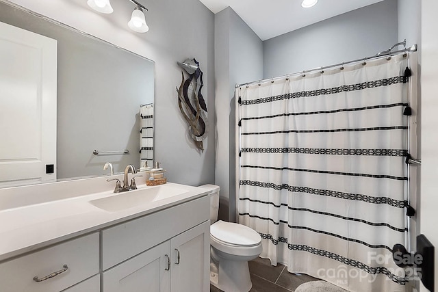 bathroom with tile patterned flooring, vanity, toilet, and a shower with curtain