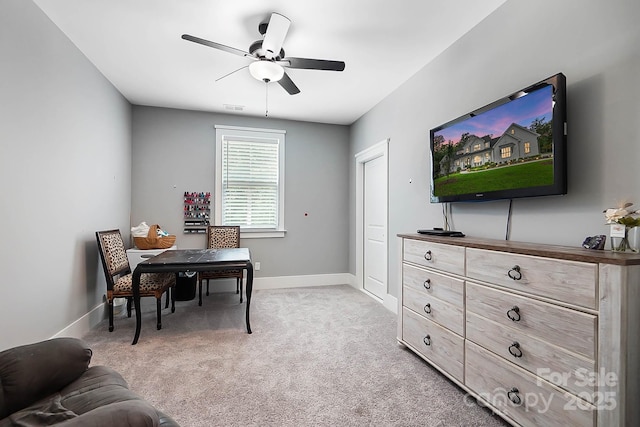 office space with light colored carpet and ceiling fan