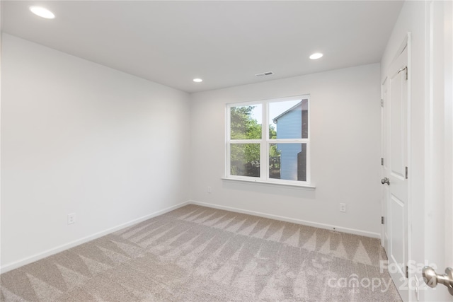 unfurnished room featuring carpet flooring