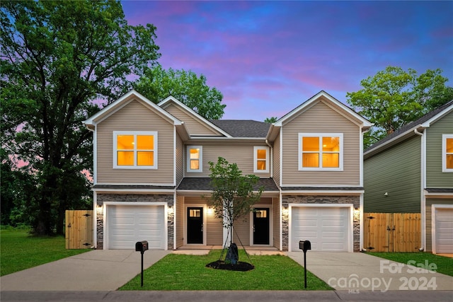 view of front of house featuring a garage and a lawn