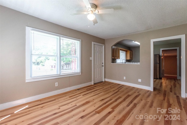 spare room featuring ceiling fan, sink, a textured ceiling, and hardwood / wood-style flooring