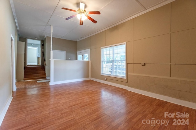 unfurnished room with ceiling fan, ornamental molding, and hardwood / wood-style floors