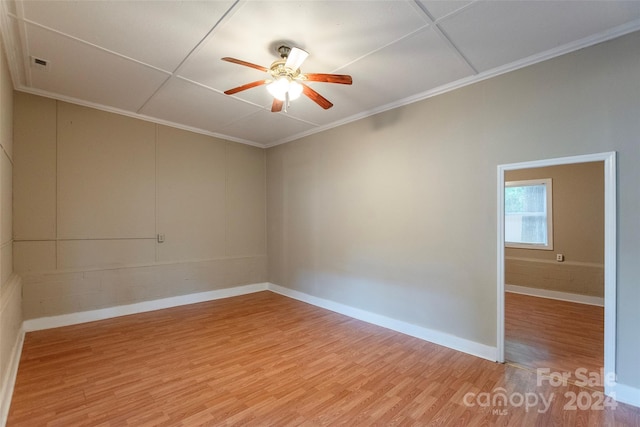 spare room featuring ceiling fan, hardwood / wood-style floors, and ornamental molding