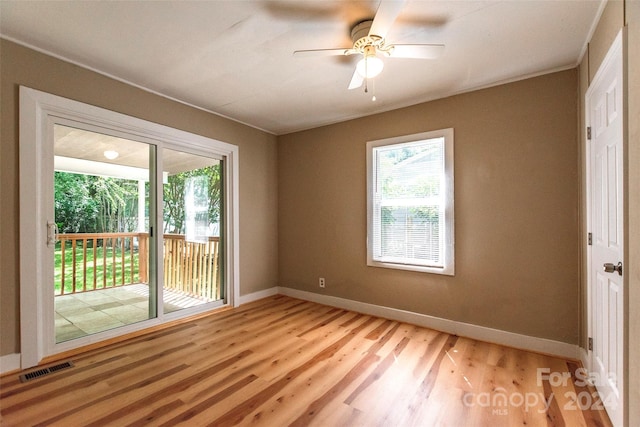 spare room featuring ceiling fan, a wealth of natural light, and light hardwood / wood-style floors