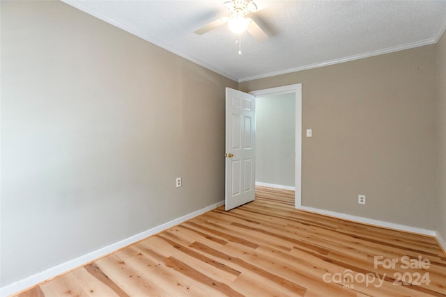 unfurnished room featuring ceiling fan, crown molding, a textured ceiling, and light hardwood / wood-style flooring