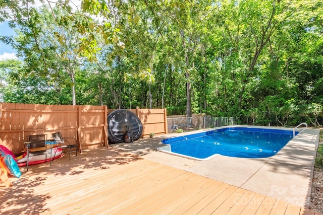 view of swimming pool with a deck