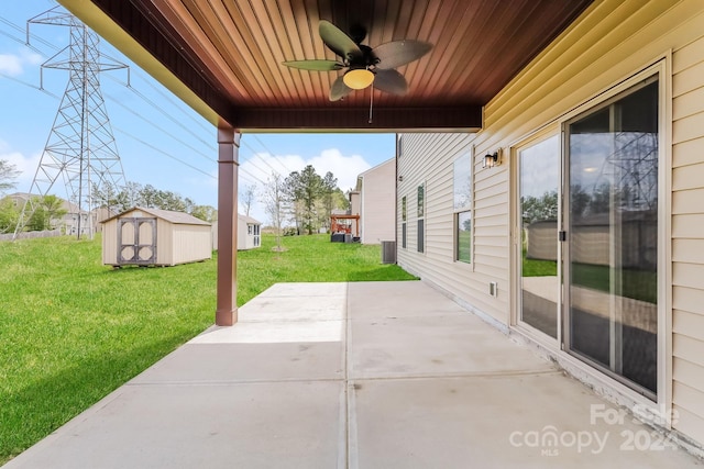 view of patio with ceiling fan and a storage unit