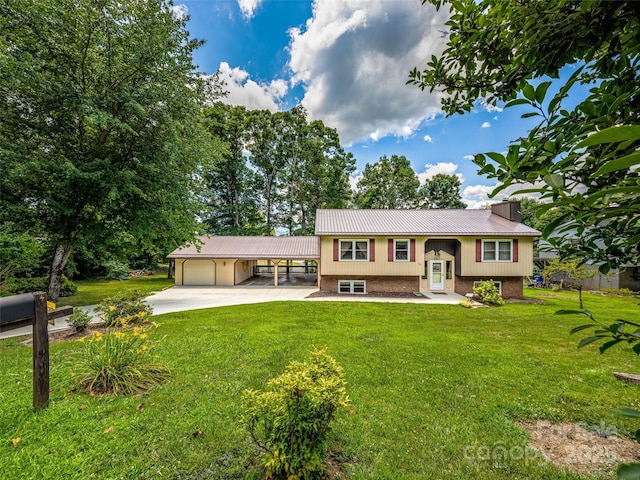 bi-level home with a front lawn and a carport