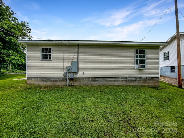 view of home's exterior with a lawn