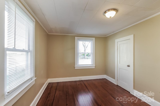 unfurnished room with dark wood-type flooring and ornamental molding