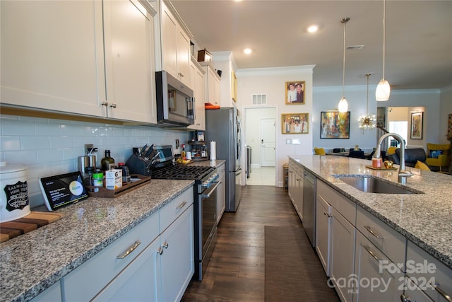 kitchen featuring sink, decorative light fixtures, stainless steel appliances, white cabinets, and light stone countertops