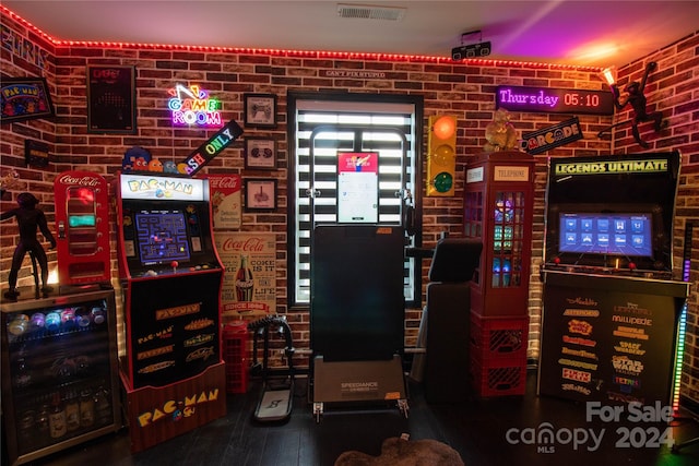 interior space featuring beverage cooler and brick wall