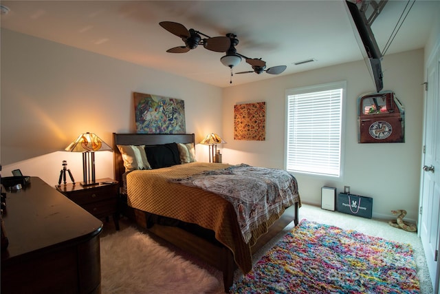 bedroom featuring ceiling fan and light carpet