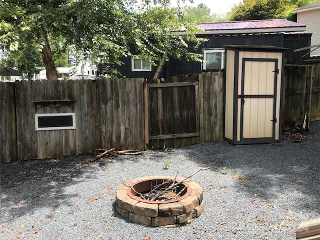 view of patio featuring a fire pit and a shed