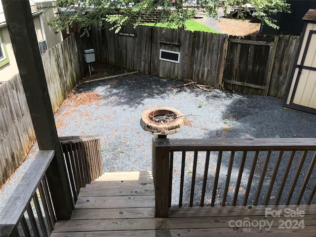 view of yard featuring a deck and a fire pit