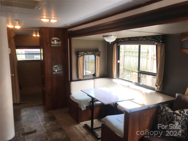 dining area with breakfast area and wooden walls