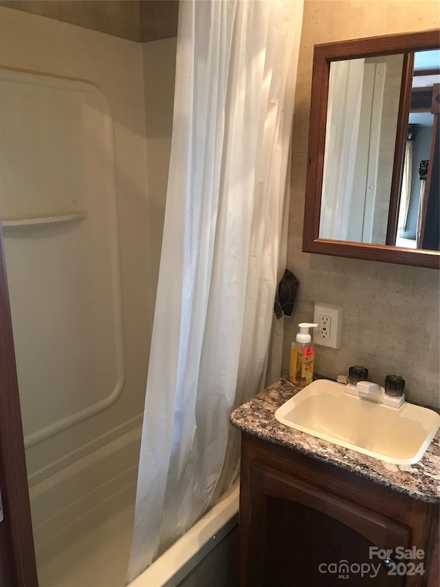 bathroom with vanity and tasteful backsplash