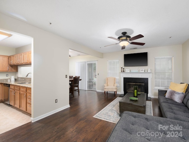 living room featuring sink, wood-type flooring, and ceiling fan