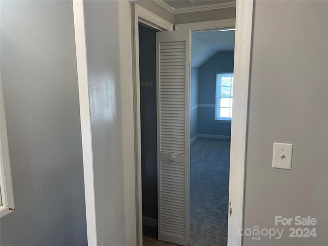 hallway featuring crown molding, carpet floors, and vaulted ceiling