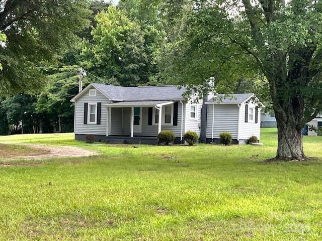 ranch-style home with a porch and a front yard