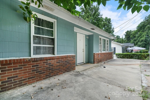 property entrance with a patio area