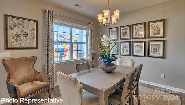 dining area with an inviting chandelier and hardwood / wood-style flooring