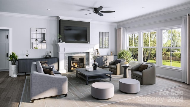 living room with ceiling fan, a premium fireplace, crown molding, and hardwood / wood-style floors