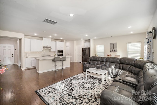 living room featuring dark wood-type flooring