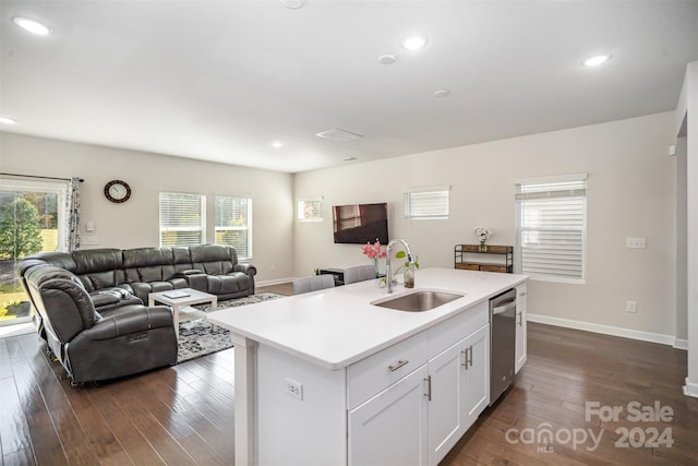 kitchen with dishwasher, sink, dark hardwood / wood-style flooring, white cabinetry, and a kitchen island with sink