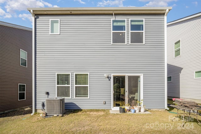 back of house featuring cooling unit and a yard