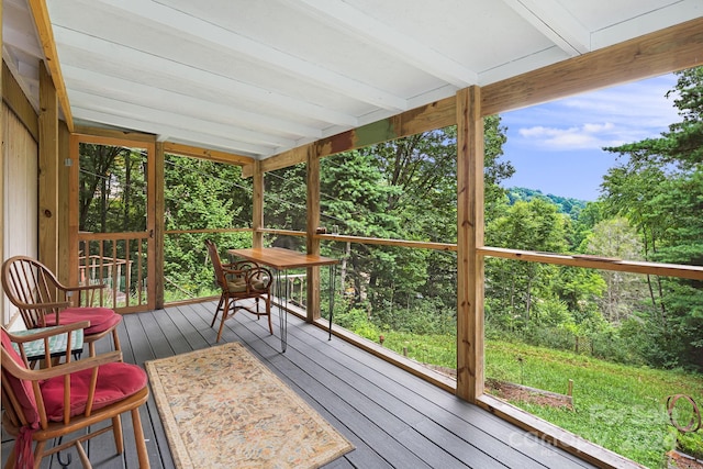 sunroom / solarium with lofted ceiling with beams