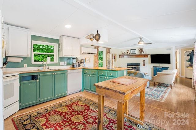 kitchen featuring sink, light hardwood / wood-style flooring, white appliances, ceiling fan, and a wall unit AC