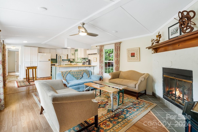 living room featuring light hardwood / wood-style flooring, an AC wall unit, lofted ceiling with beams, ceiling fan, and crown molding