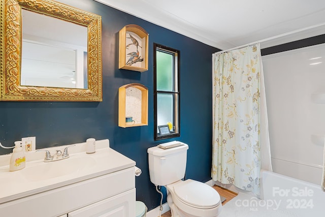 full bathroom featuring ornamental molding, vanity, shower / tub combo, and toilet