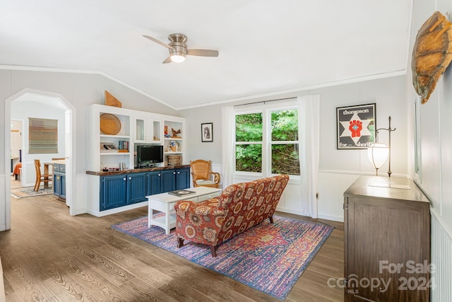 living room with ceiling fan, vaulted ceiling, light hardwood / wood-style flooring, and crown molding