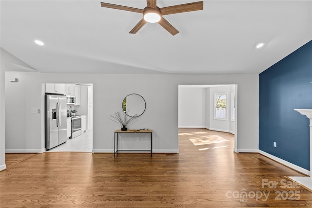 entryway featuring ceiling fan and light wood-type flooring