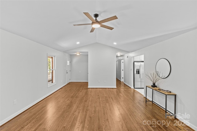 interior space with ceiling fan, lofted ceiling, and light hardwood / wood-style floors