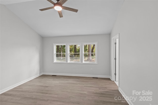 unfurnished room featuring vaulted ceiling, ceiling fan, and light hardwood / wood-style floors