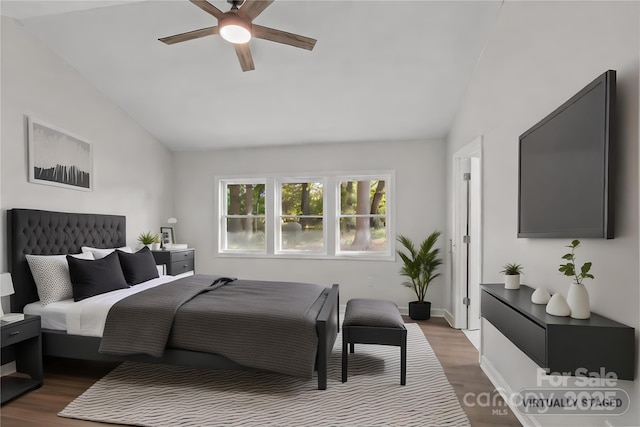 bedroom with lofted ceiling, dark hardwood / wood-style flooring, and ceiling fan