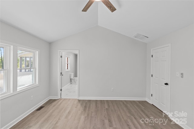 spare room with ceiling fan, lofted ceiling, and light hardwood / wood-style floors