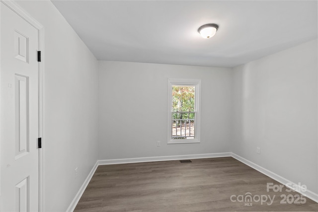 unfurnished room featuring hardwood / wood-style flooring