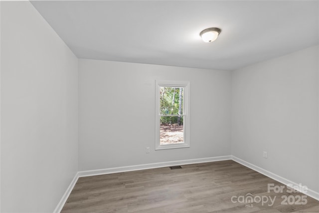 empty room with hardwood / wood-style floors